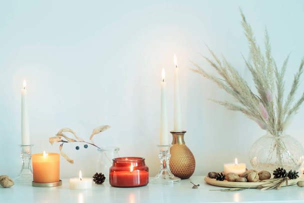 autumn home decorations with burning candles - Foto, afbeelding