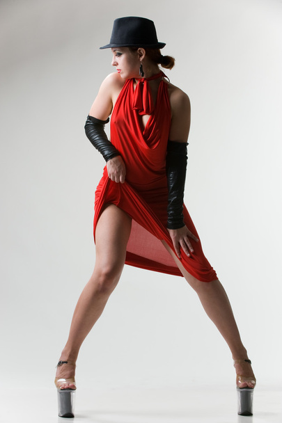 Sexy woman in red dress and black hat. - Valokuva, kuva
