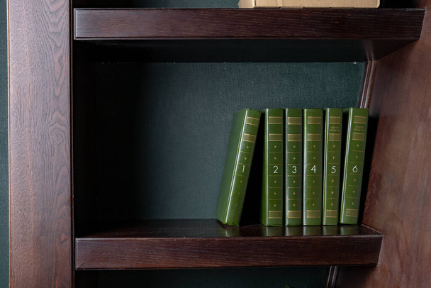 A book with a green cover to stand on a shelf bookcase - Foto, imagen