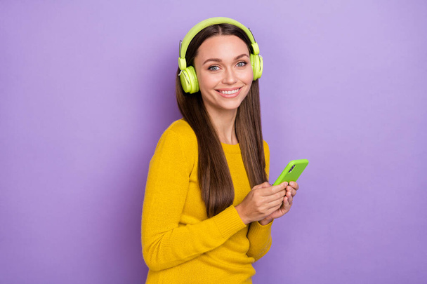 Profile side photo of young cheerful girl listen earphones melody sound meloman mobile isolated over purple color background - Φωτογραφία, εικόνα