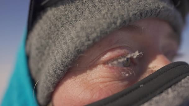 Close up, woman with face guard mask. Eyelashes with hoarfrost. Cold protection - Footage, Video
