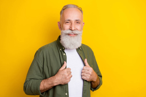 Photo portrait of elder man smiling wearing green shirt isolated vivid yellow color background - Photo, image