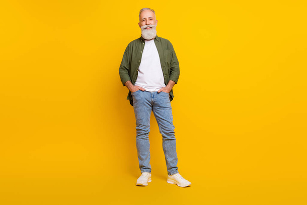 Full length body size photo of senior man smiling cheerful wearing stylish outfit isolated vibrant yellow color background - Фото, зображення