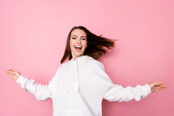 Photo of young cheerful girl happy positive smile excited wear hoodie isolated over pink color background - Foto, imagen