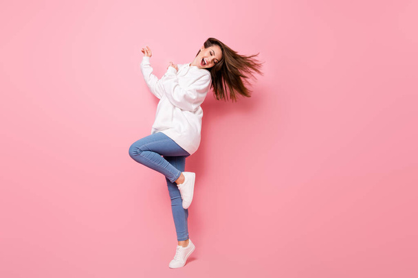 Full size photo of attractive young woman wear casual clothes wind fly hair good mood isolated on pink color background - Foto, imagen