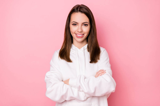 Photo of adorable confident young lady wear white hoodie glasses smiling arms folded isolated pink color background - Foto, Bild