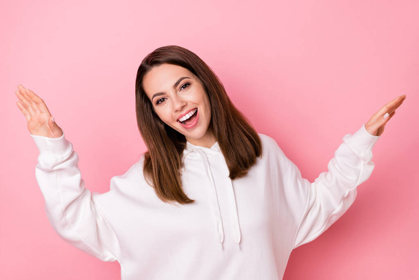 Photo of joyful happy young woman wear casual white hoodie smile enjoy isolated on pink color background - Фото, изображение