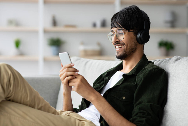 Handsome indian guy watching video on smartphone - Photo, image