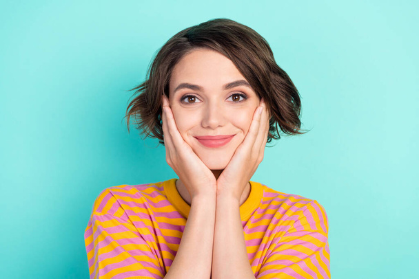 Portrait of attractive calm cheery brown-haired girl touching face isolated over bright teal turquoise color background - Fotó, kép