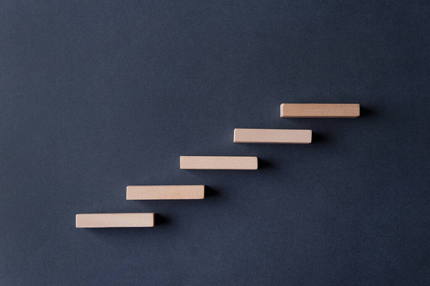 Wooden block steps on a gray-blue background. Concept. Rise up. Height. Stair. Promotion - Fotoğraf, Görsel