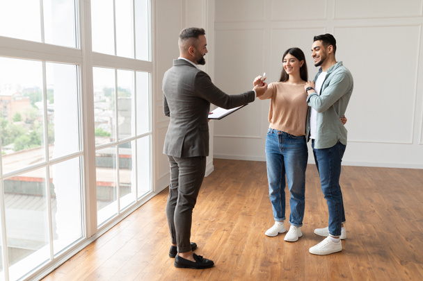 Real Estate Agent Giving Keys To Excited Buyers - Photo, Image