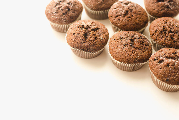 Chocolate muffins on a white plate. Confectionery.  - Фото, изображение