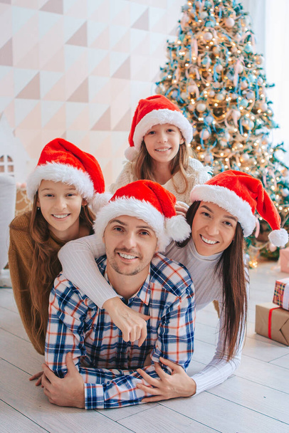 Happy young family with kids holding christmas presents - 写真・画像