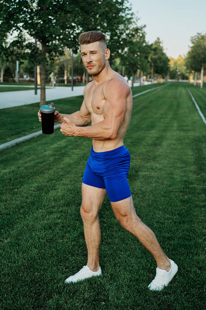 sports muscular man in the park healthy food fitness - Фото, изображение