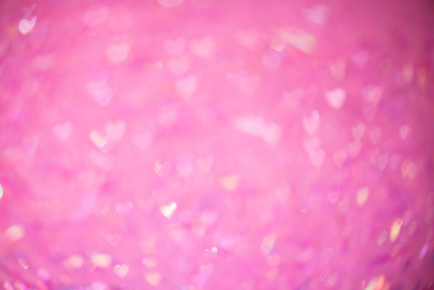 Naturale bokeh rosa di luci a forma di cuore, sfocato fuori fuoco sfondo. - Foto, immagini