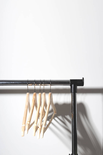 Empty clothes hangers on plain. Conscious consumption slow fashion concept. Minimalist. - Фото, зображення