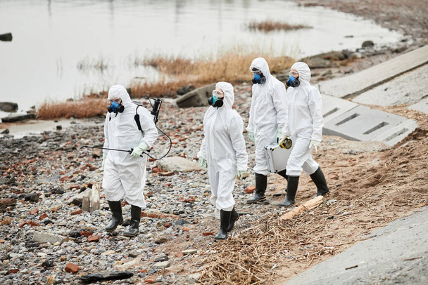 Workers in Hazmat Suits at Eco Disaster Site - Photo, image