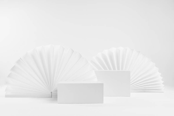 White scene mockup with set of two rectangle box podiums for presentation, show, display of cosmetic product with light asian ribbed paper fans decoration in fashion elegant style, front view. - Φωτογραφία, εικόνα