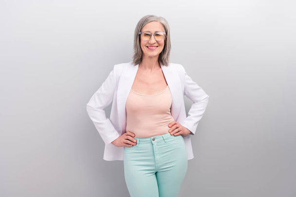Photo of nice white hairdo old teacher lady wear spectacles jacket pants smart casual isolated on grey color background - Zdjęcie, obraz