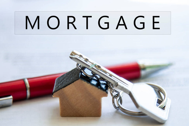 key with house key ring, contract and pen. home mortgage, rental or sale signing concept - Photo, Image