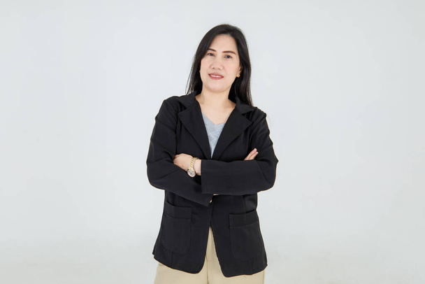 Очаровательная деловая леди, стоящая с уверенностью на умной куртке и привлекательно улыбающаяся со сложенными руками на успешном менеджере моды - Фото, изображение