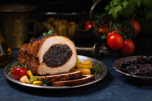 Whole roasted pork loin stuffed with dried plum. - Zdjęcie, obraz