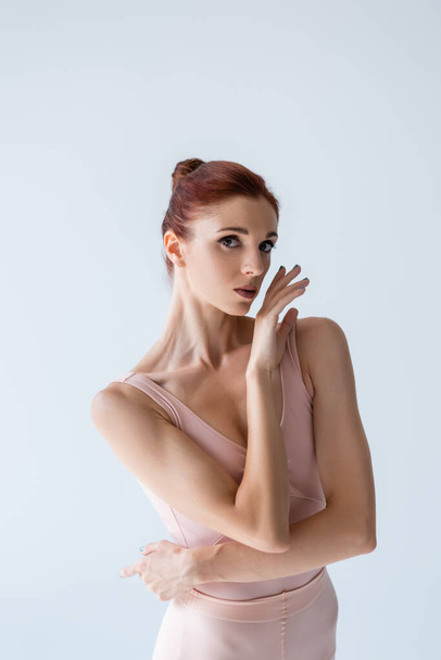 redhead ballerina looking at camera isolated on grey - Foto, afbeelding
