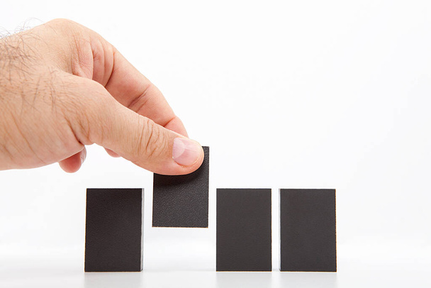  Man chooses one of many wooden blocks. Business concept. Choose the ideal person from many candidates. - Photo, image