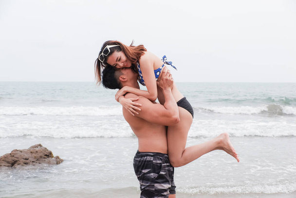 Portrait asian couple in love, sexy bikini on the beach, happy life on summer season - Foto, immagini