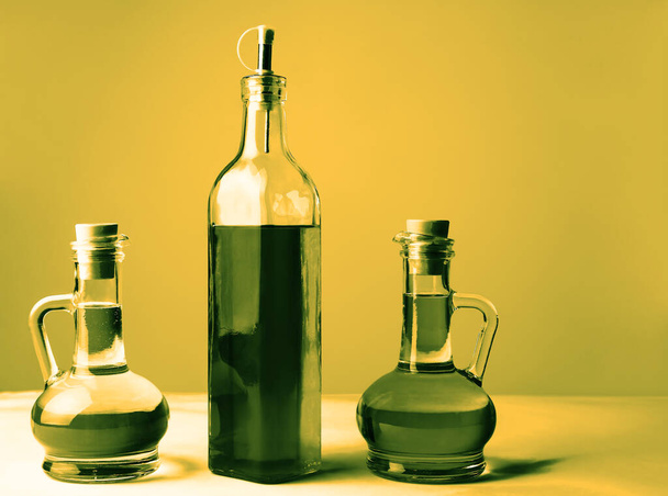 Set of vegetable or olive oil glass bottles  on isolated  background. The collection of three narrow and high bottles. - 写真・画像