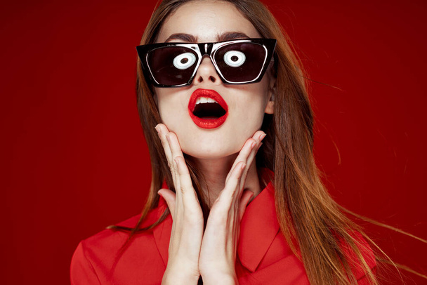 glamorous woman wearing sunglasses red shirt hairstyle model - Foto, Bild