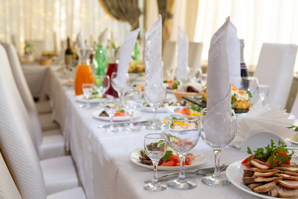 Beautiful table served with glassware and cultery, prepared for festive event. Special occasion celebrted in luxury restaurant or cafe. Table setting concept. Wedding table. - Φωτογραφία, εικόνα