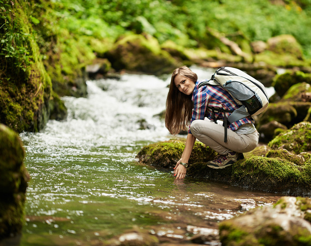 Young woman hiker by the river - Fotoğraf, Görsel
