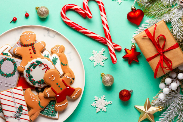 Christmas composition with decorations and cookies on a mint background. - Valokuva, kuva