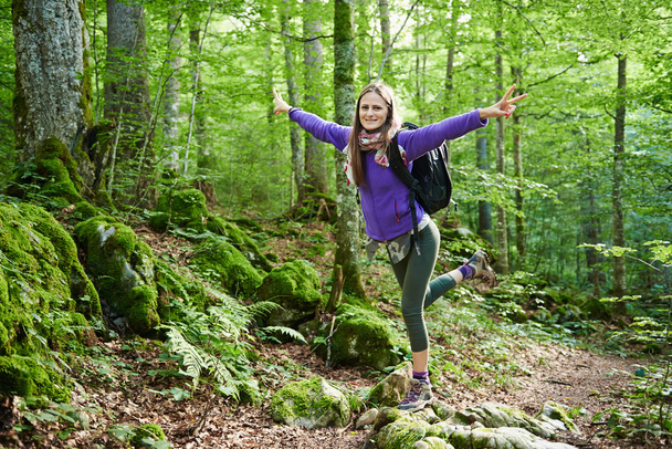 Woman with backpack hiking into the forest - Foto, Imagen