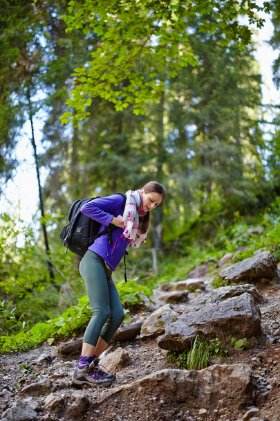 Woman with backpack hiking into the forest - Foto, imagen