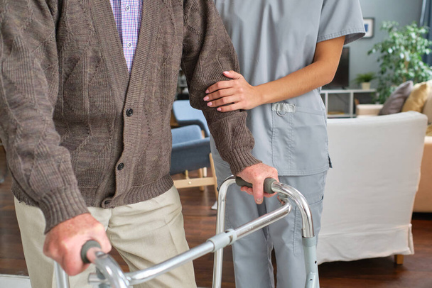 Elderly person moving with the help of a walker - Photo, Image