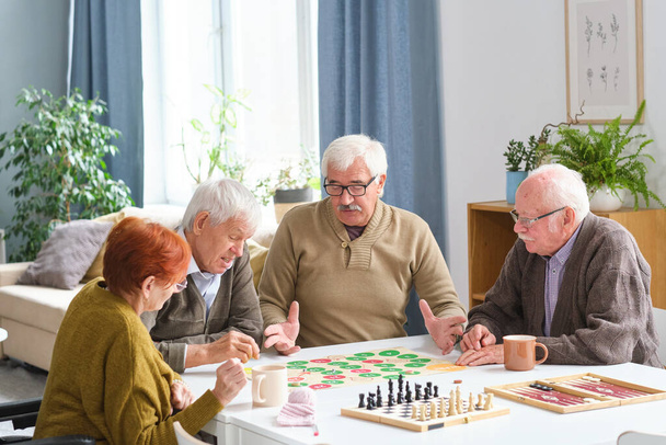 Elderly people playing board game - Photo, Image