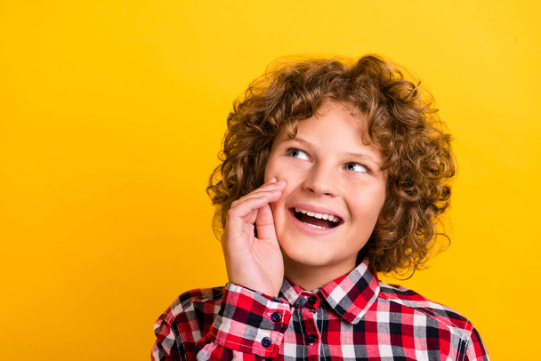 Photo of funny red curly hairdo small boy tell secret wear plaid shirt isolated on yellow color background - Φωτογραφία, εικόνα