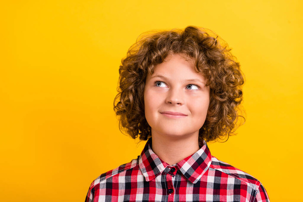 Photo of nice ginger hairdo teen boy look empty space wear red plaid shirt isolated on yellow color background - Фото, зображення
