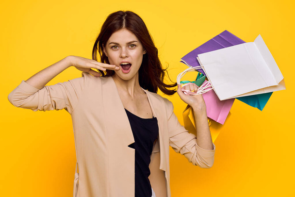 smiling woman shopping entertainment lifestyle yellow background - Фото, изображение