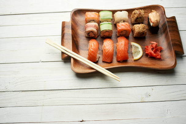 sushi wooden plate chopsticks traditional food restaurant - Fotografie, Obrázek