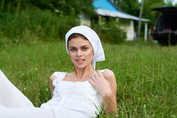 Woman in white dress in the village outdoors Green grass Farmer - Фото, зображення