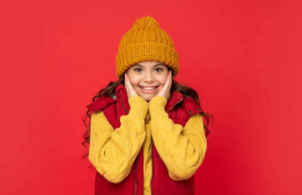 express positive emotion. winter fashion. glad kid with curly hair in hat. female fashion model. - Фото, изображение