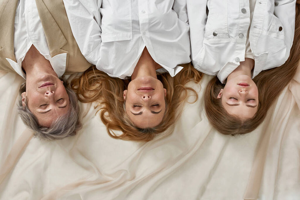 Top view of three generations of women sleep see dreams - Foto, Bild