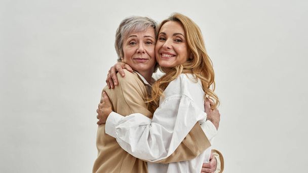 Portrait of smiling adult daughter and mature mom - Photo, Image