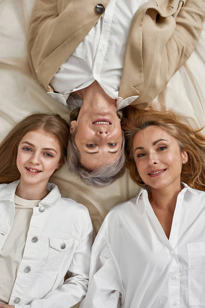 Narrow top view of smiling three women generations - Photo, image