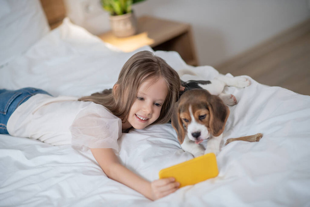 Female child taking selfies with her dog - Foto, Imagen