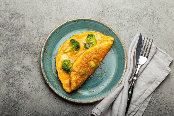 Healthy omelette with broccoli on plate top view - 写真・画像