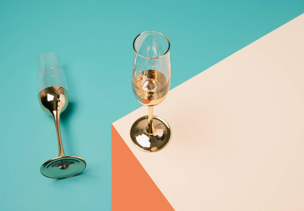Champagne glasses arranged on a geometric perspective background. Minimal New Year celebration concept. - Photo, image